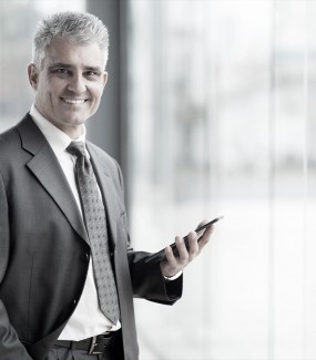 portrait of senior business executive using tablet pc